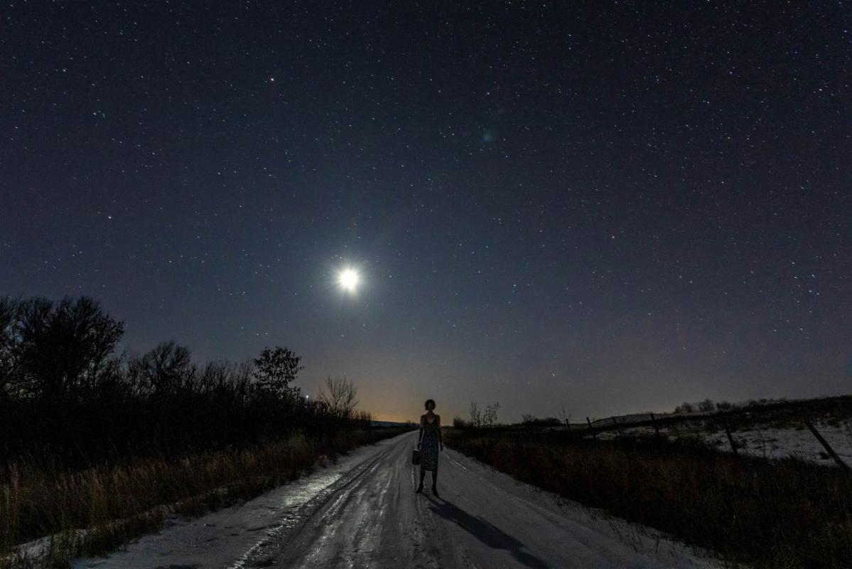 Woman traveler under the moon height=