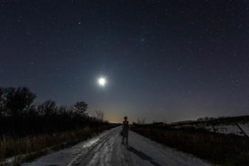 Woman traveler under the moon
